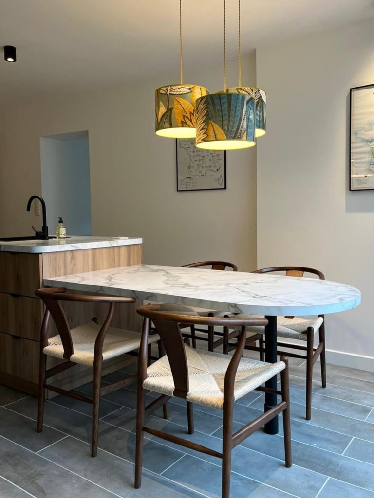 Îlot central en marbre et bois avec abat-jour sur mesure dans une cuisine moderne. Architecture d'intérieur Angers